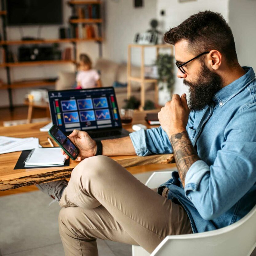 cryptocurrency investor trading at home using his smartphone cryptocurrency investor trading at home using his smartphone